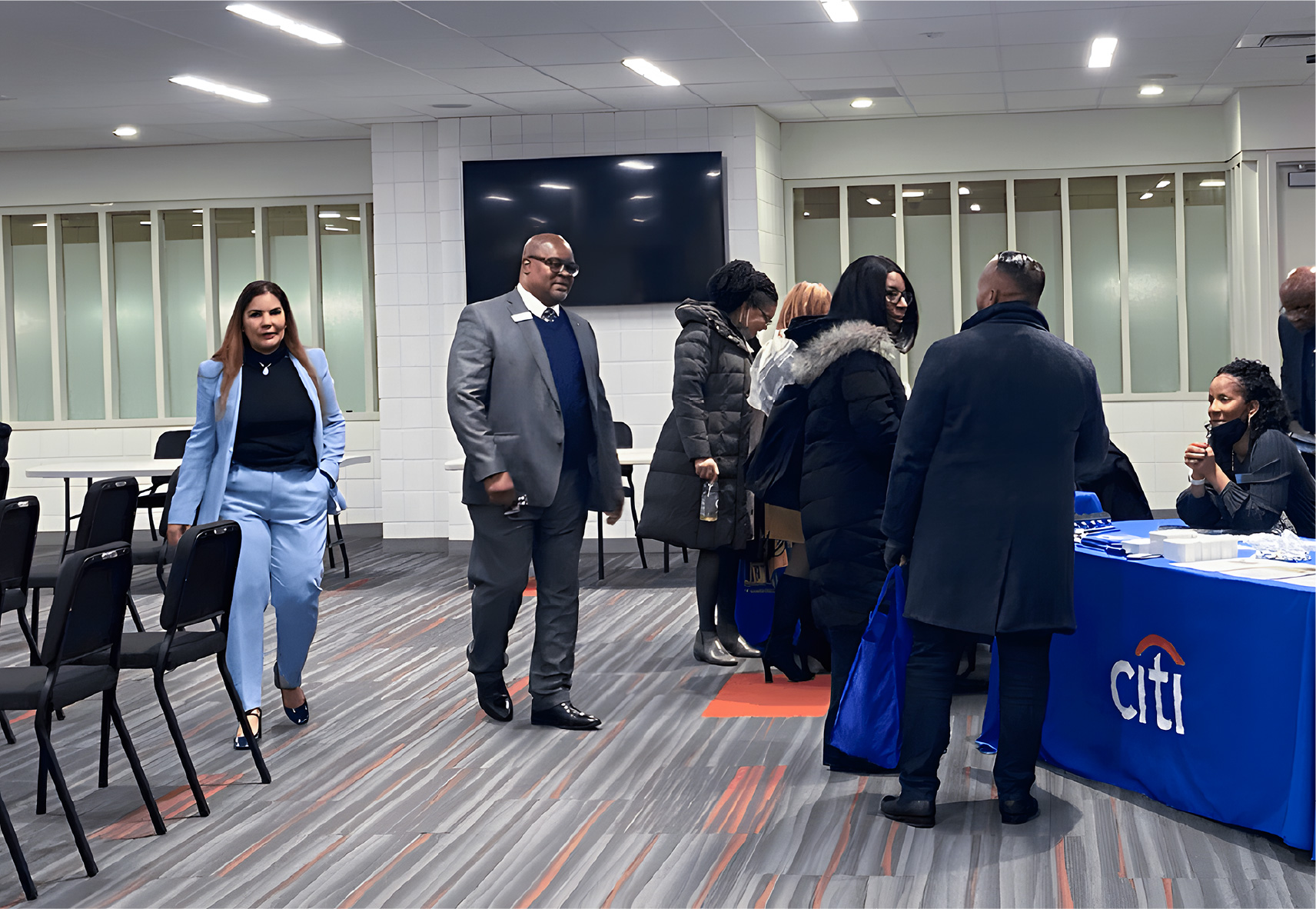 Group of African American people gathered at a convention, engaging in discussions and networking.